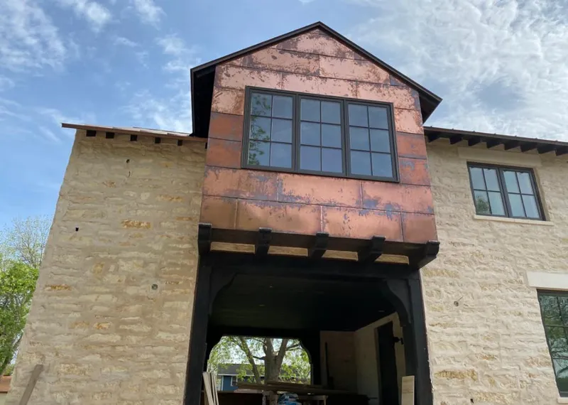Copper metal panel facade on a stone building for Skylight Installation in Barnesville